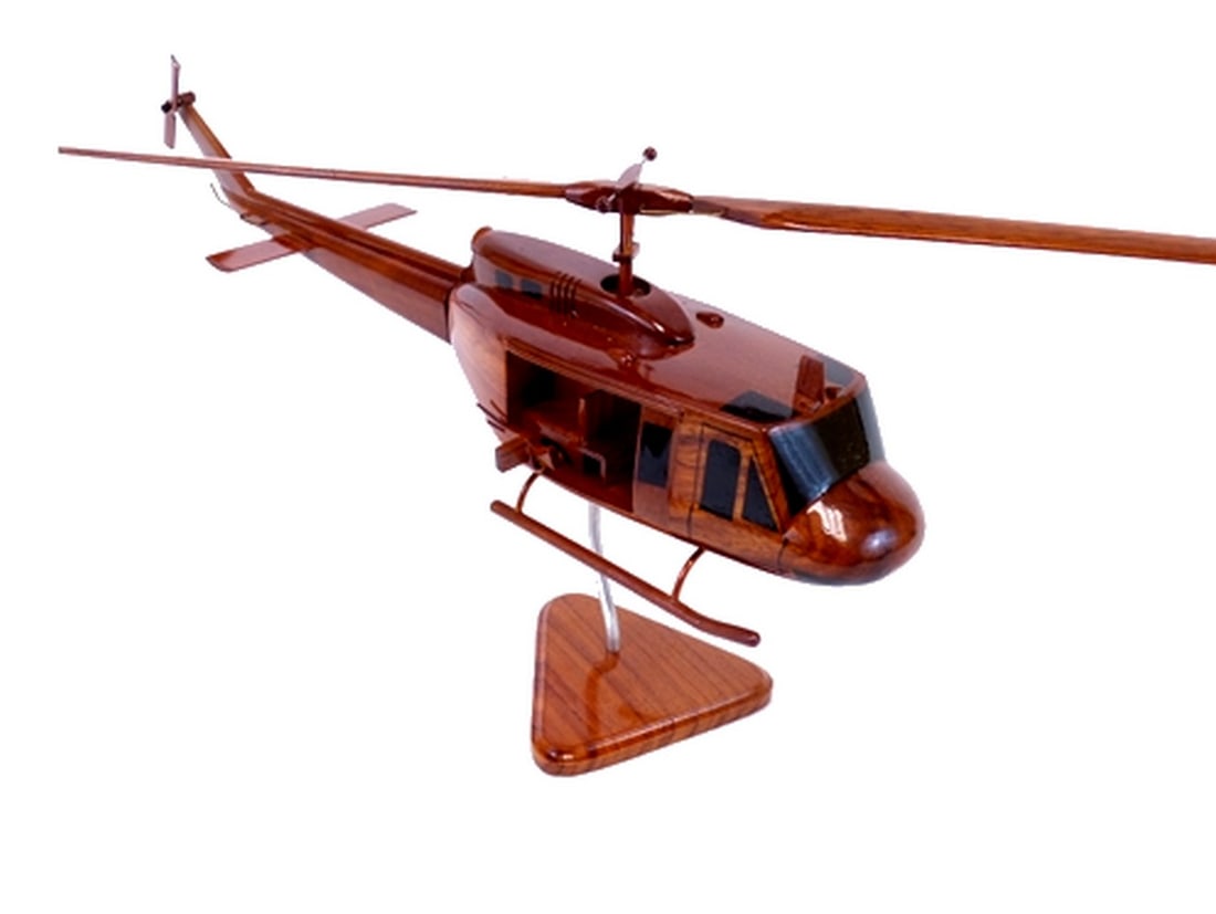 UH-1 Bell Huey Helicopter: UH-1 Bell Huey Helicopter This exceptionally detailed wood model of the UH-1 Bell Huey helicopter is hand crafted from solid mahogany. Open gun doors reveal interior detailing of the seating in the