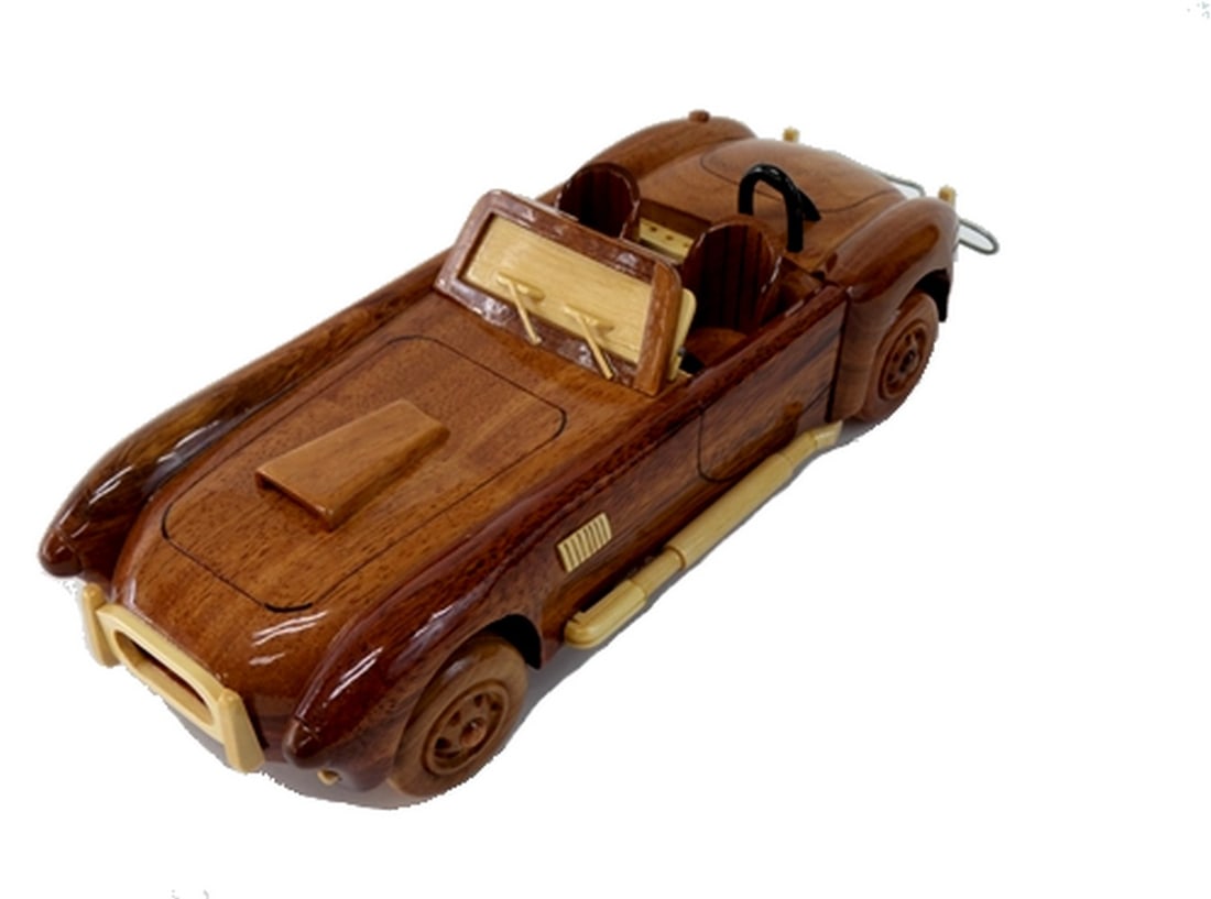 Cobra Car: Cobra Car The Cobra Car is beautifully recreated in this handcrafted scale model. Made of solid mahogany and finely detailed, this classic car in a clear polyurethane high gloss finish has deep wood