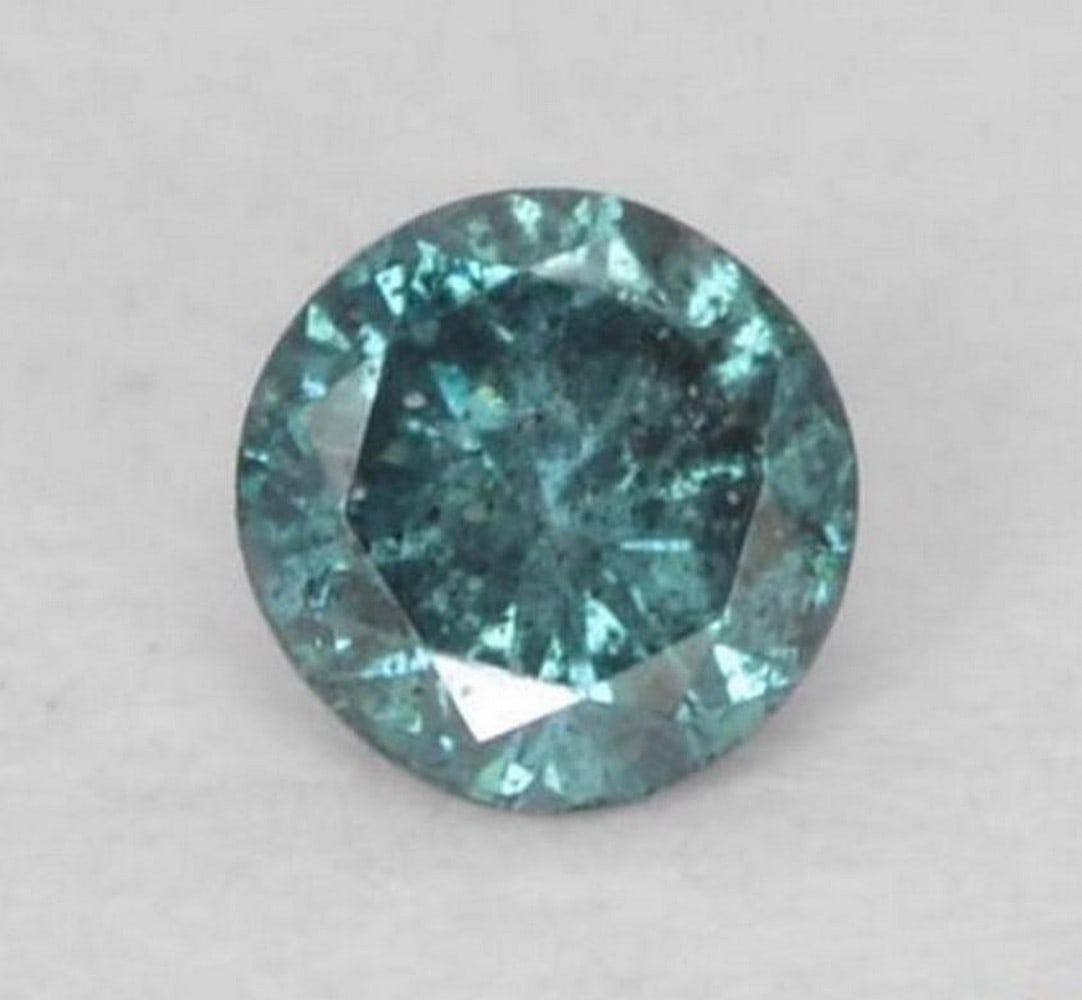 0.05 ct Round Natural Blue Diamond: 0.05 ct Round Natural Blue Diamond Introducing the Round Natural Blue Diamond, a delicate gem displaying a soft blue hue with VS-SI clarity. This irradiated diamond from India features a precise