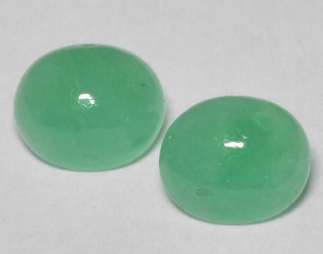 1.22 ct Oval Cabochon Natural Pistachio Green Emerald Gems: 1.22 ct Oval Cabochon Natural Pistachio Green Emerald Gems Introducing the Oval Cabochon Natural Pistachio Green Emerald Gems, a pair of translucent emeralds with soft green hues. Each gem has been