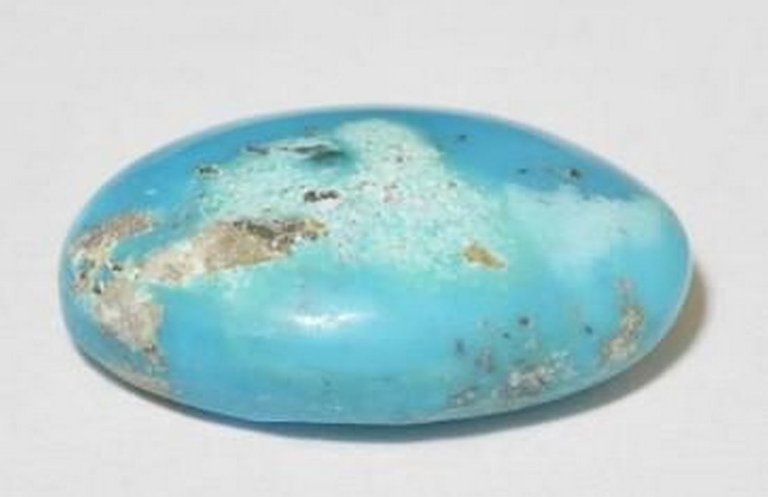 22.44ct Vibrant Green-Blue Turquoise Gemstone: 22.44ct Vibrant Green-Blue Turquoise Gemstone A captivating 22.44-carat natural turquoise gemstone in an elegant oval shape, showcasing a unique greenish-blue hue. This opaque gem carries the classic