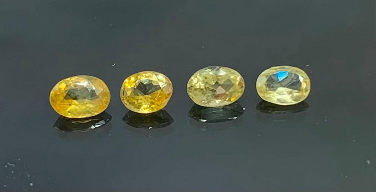 Four 0.47ct Oval Cut Bright Yellow Ceylon Sapphire Gemstones: Four 0.47ct Oval Cut Bright Yellow Ceylon Sapphire Gemstones Meticulously sourced from the gem-rich mines of Sri Lanka, these gemstones are a testament to the timeless allure of sapphires.