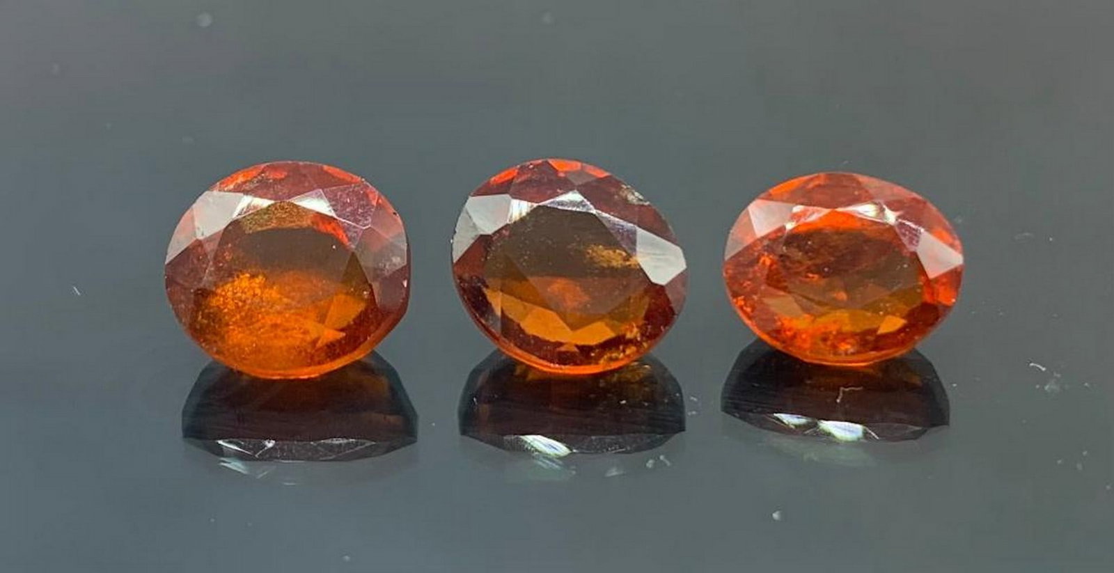 Three 10.42ct Total Deep Orange Oval Cut Hessonite Garnets: Three 10.42ct Total Deep Orange Oval Cut Hessonite Garnets These exceptional gemstones have been meticulously hand-selected for their exceptional quality, alluring color, and impeccable clarity. Hesso