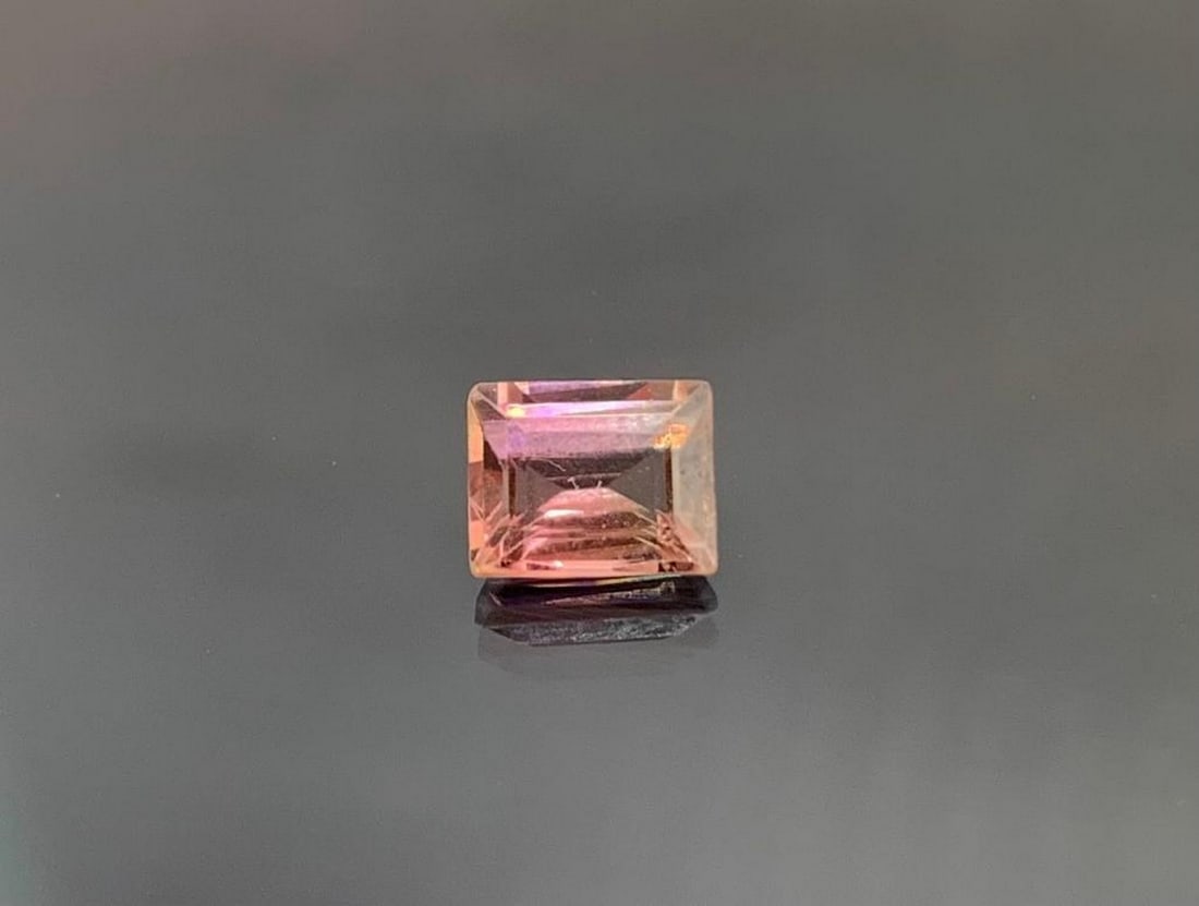 0.9ct Emerald Cut Padparadscha Tourmaline: 0.95ct Emerald Cut Padparadscha Tourmaline Size: 5 x 4mm Total Carat Weight: 0.95ct Untreated Beautiful stone with only small air bubble inclusions, a common blemish in tourmaline due to its growth in