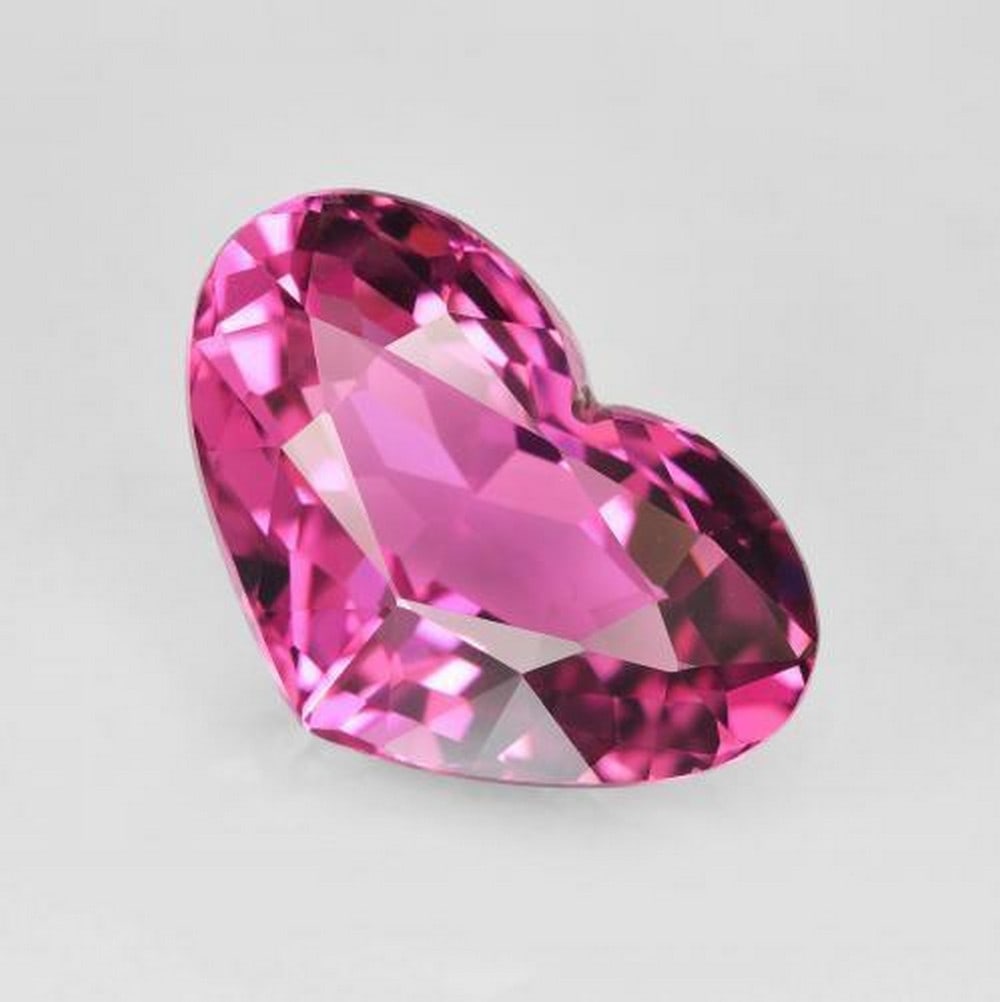 4.1ct Heart Cut Faceted Grape Purple Tourmaline Gemstone: 4.1ct Heart Cut Faceted Grape Purple Tourmaline Gemstone Experience the captivating beauty of our 4.1ct Heart Cut Faceted Grape Purple Tourmaline Gemstone. This exquisite gem dazzles with its rich gra