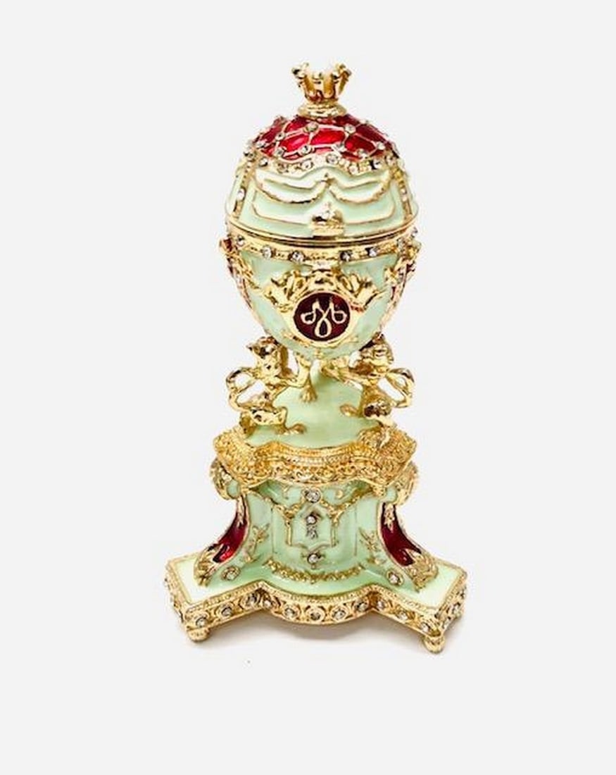 1903 Royal Danish Russian Inspired Egg: 1903 Royal Danish Russian Inspired Egg You'll love the elegance of this white-hued, Imperial Easter egg. A display stand attached to this beauty, fashioned from fine pewter. Then it is hand enameled