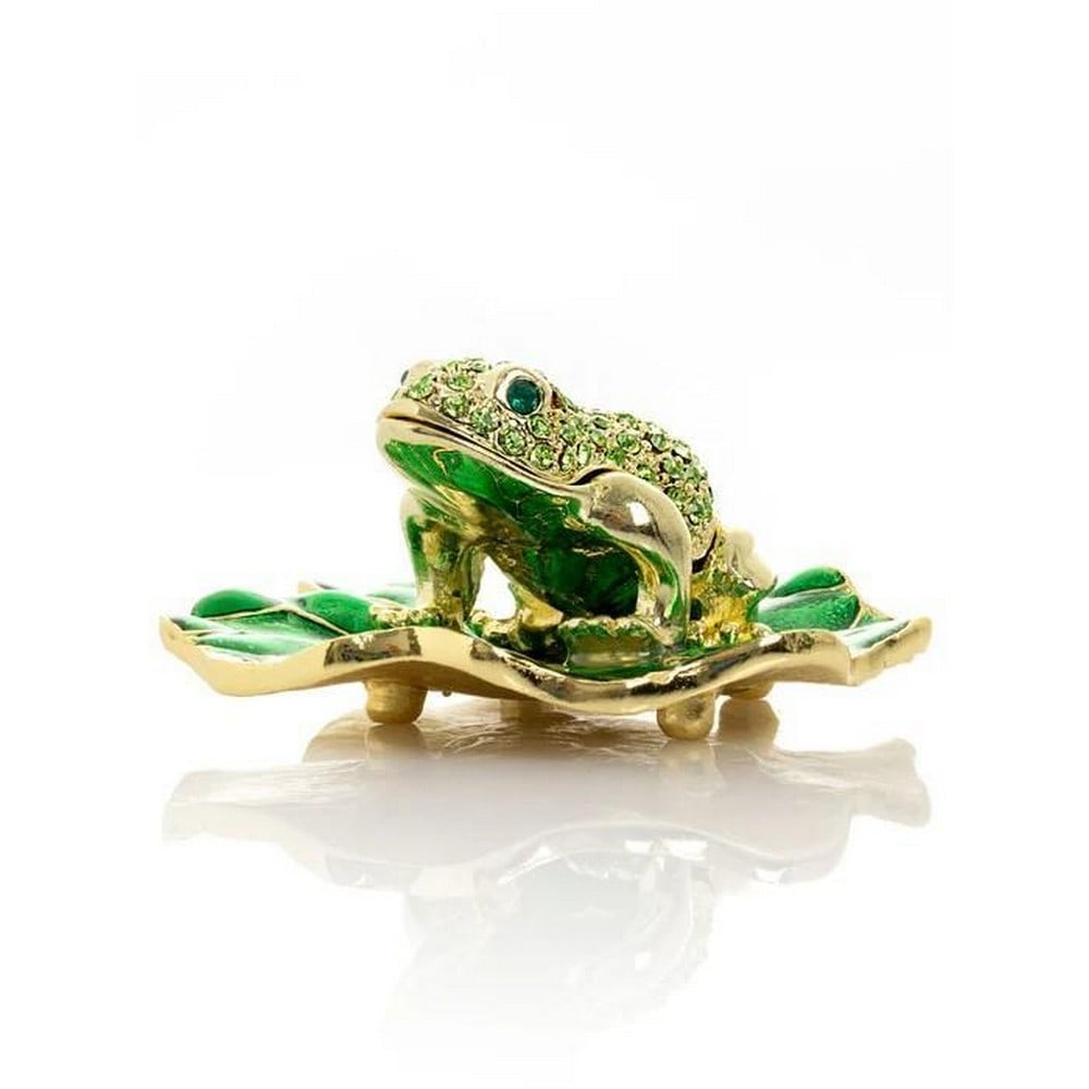 Golden Frog Trinket Box on Leaf: Golden Frog Trinket Box on Leaf Perched gracefully atop a glossy green leaf, this golden frog trinket box brings a playful touch of nature-inspired charm. The frog's metallic finish shimmers with