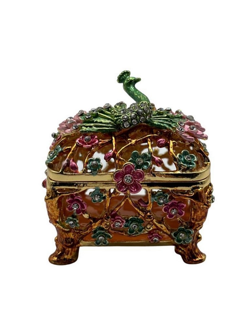 Floral Peacock Trinket Box: Floral Peacock Trinket Box This trinket box features a peacock motif adorned with delicate floral patterns. The box is made from high-quality metal that has been expertly enameled, resulting in a smoo