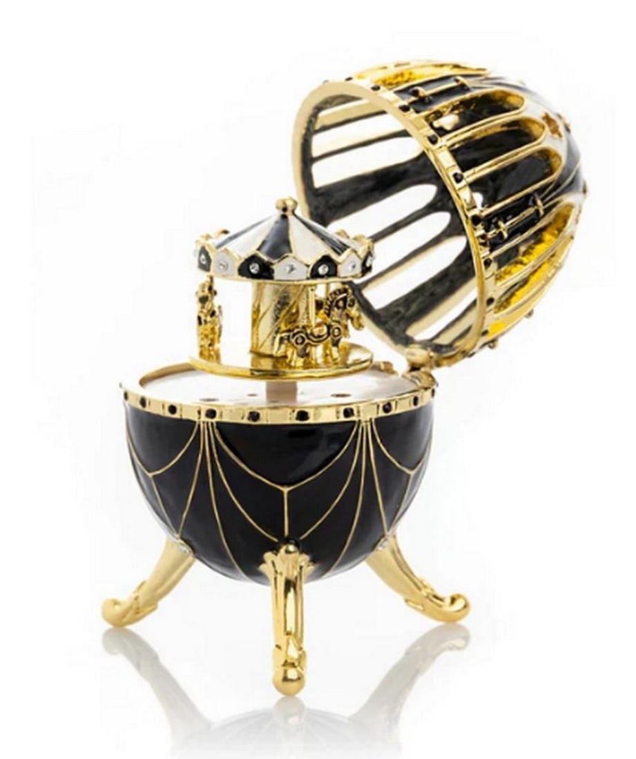 Black and Gold Faberge Inspired Egg with Horse Carousel: Black and Gold Faberge Inspired Egg with Horse Carousel Handmade Trinket Box Decorated with Austrian Crystals and Gold Plated. Plays the melody of Fur Elise by Ludwig Van Beethoven. A splendid handmad