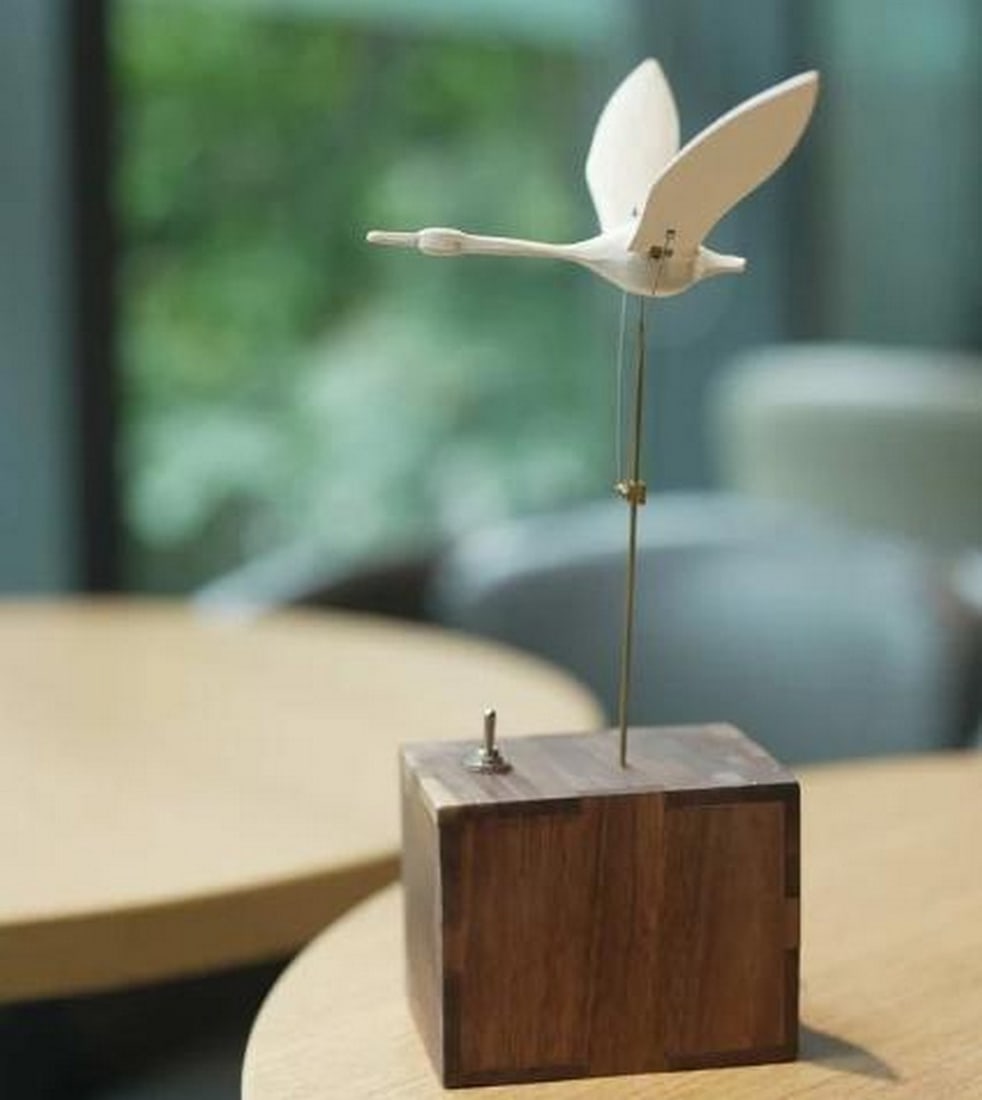 Handcrafted White Swan Musical Automaton in Walnut Wood: Handcrafted White Swan Musical Automaton in Walnut Wood Elegant and serene, this handcrafted automaton features a beautifully sculpted swan painted in a soft white finish, gracefully gliding with life