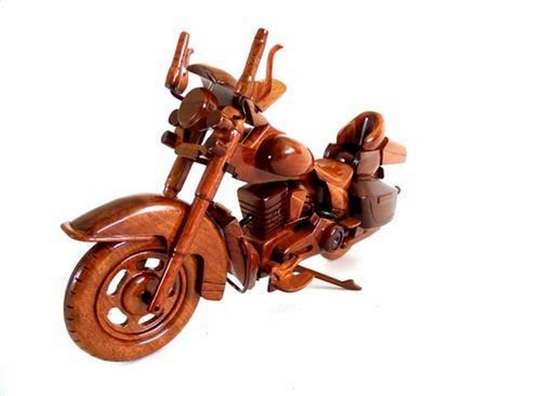 Harley Davidson Electra Glide Wooden Model Bike: Harley Davidson Electra Glide Wooden Model Bike This classic Harley Davidson Electra Glide model is meticulously handcrafted from mahogany, featuring a working kickstand and movable handlebars. It is 