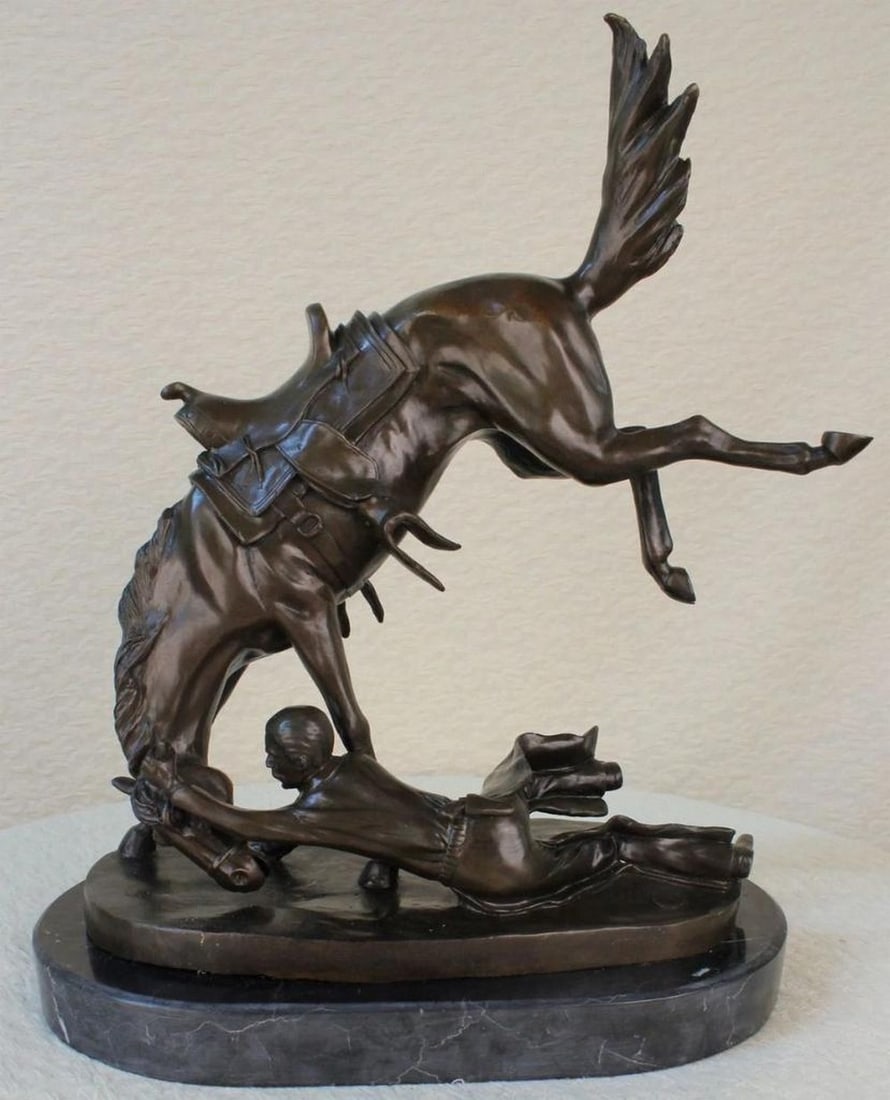 Inspired Signed Cowboy & Stallion Western Bronze Statue - 18'' x 18'': Inspired Signed Cowboy & Stallion Western Bronze Statue - 18" x 18" This dramatic bronze sculpture embodies the untamed spirit of the American West, portraying a cowboy locked in a fierce strugg