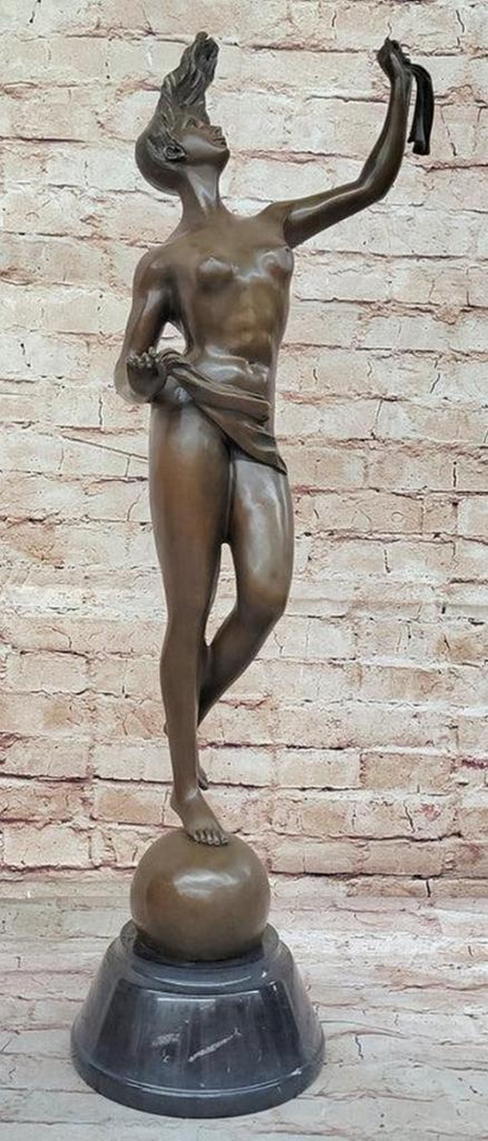 Nude Female Dancer Holding Conch Shell Bronze Statue - 30'' x 8'': Nude Female Dancer Holding Conch Shell Bronze Statue - 30" x 8" A late 19th-century bronze goddess figure, cast after a model by Cattaneo, known for his contributions as both a sculptor and poet