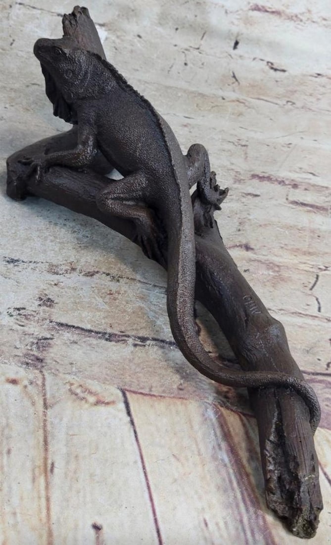 Reptilian Life: Iguana on A Tree Branch Bronze Sculpture - 4'' x 13'': Reptilian Life: Iguana on A Tree Branch Bronze Sculpture - 4" x 13" This is an exquisitely representational sculpture of an iguana. It` s lifelike quality is impressive as the beholder can