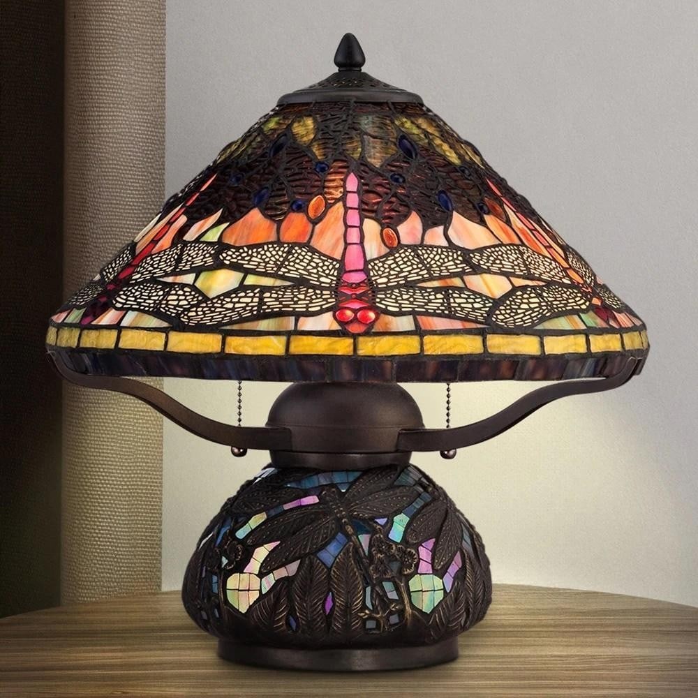 Verdant Dragonfly Tiffany Table Lamp: Verdant Dragonfly Tiffany Table Lamp This 16.5-inch Tiffany-style table lamp features a conical stained glass shade in rich tones of green, amber, blue, and yellow, adorned with a stylized dragonfly m