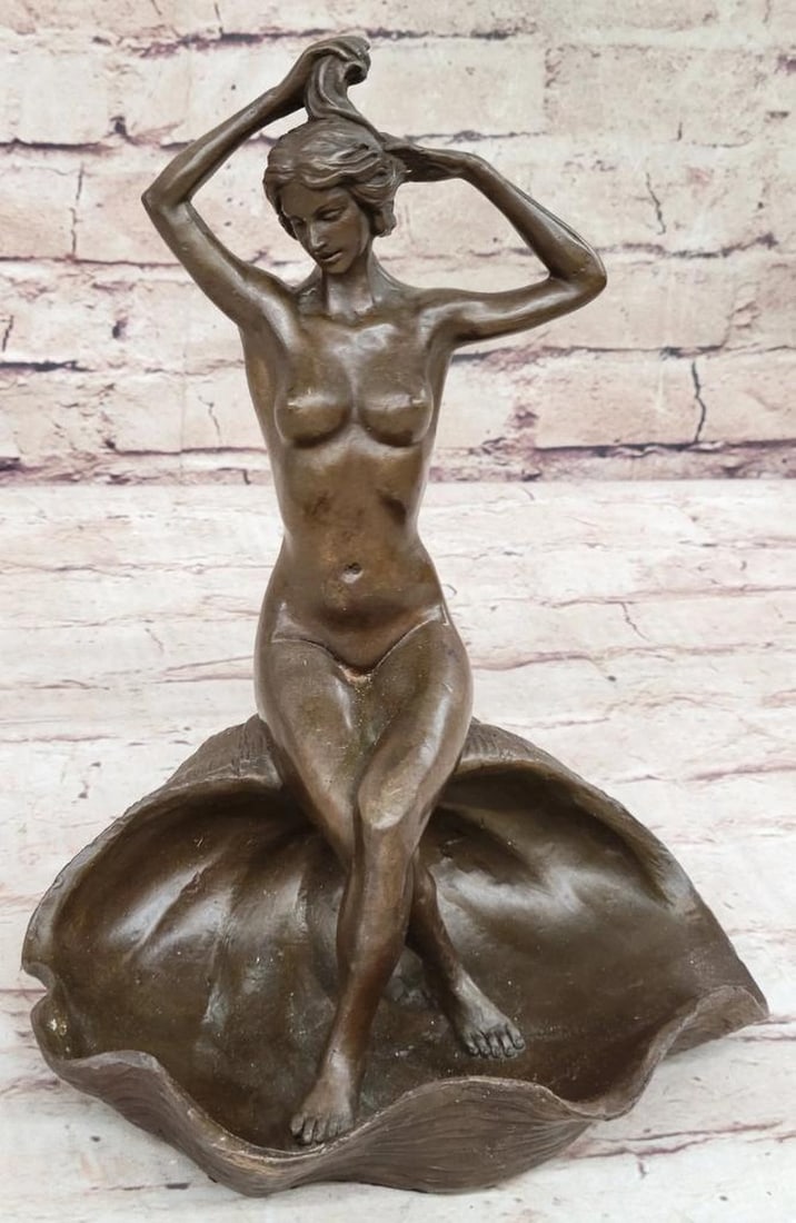 Nude Women Sitting on Seashell Inspired Bronze Statue - 9'' x 7.5'': Nude Women Sitting on Seashell Inspired Bronze Statue - 9" x 7.5" This enchanting sculpture depicts a nude woman reclining gracefully on a blossomed flower, exuding sensuality and serenity. With