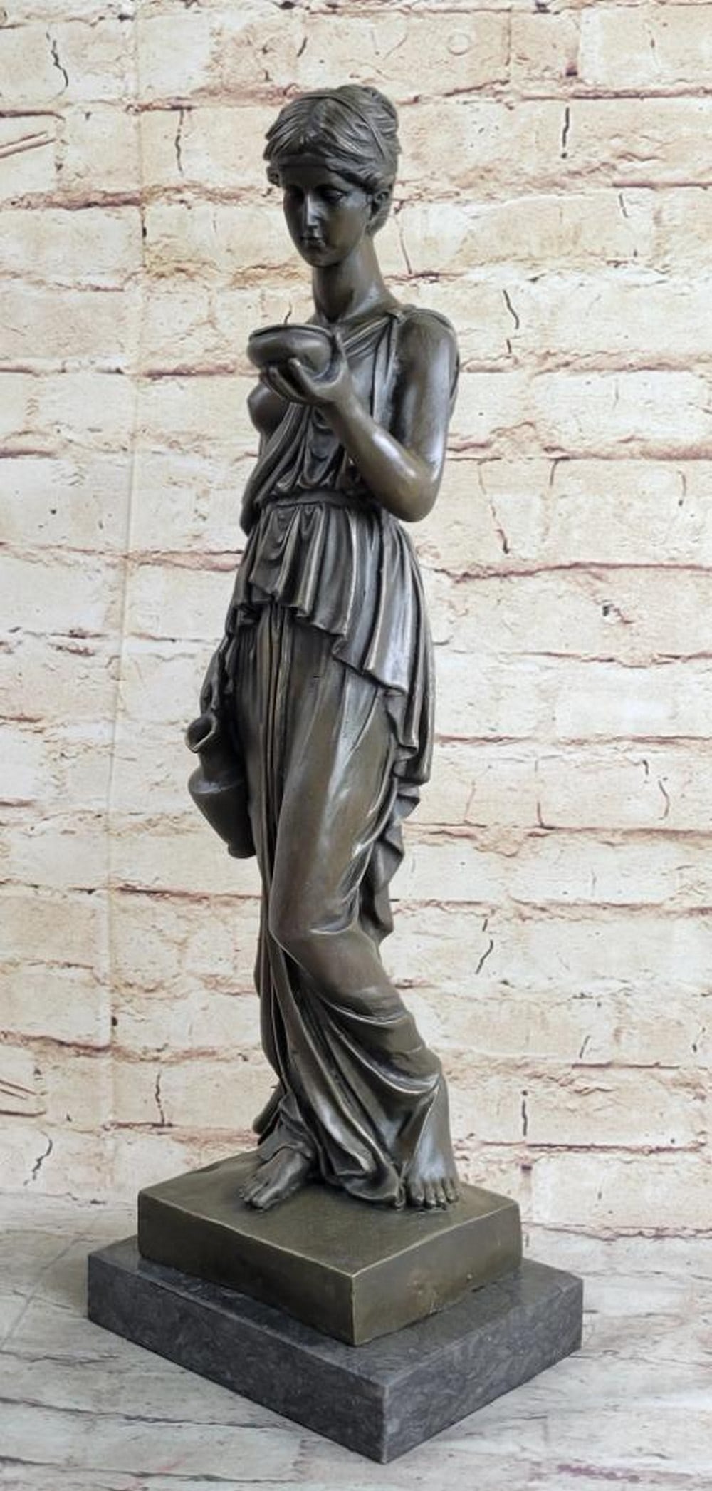 Inspired Bronze Young Lady Offering Water Sculpture - 20'' x 6.5'': Inspired Bronze Young Lady Offering Water Sculpture - 20" x 6.5" This elegant bronze sculpture by Milo portrays a young woman in a moment of quiet service, offering water with a jug and bowl in 