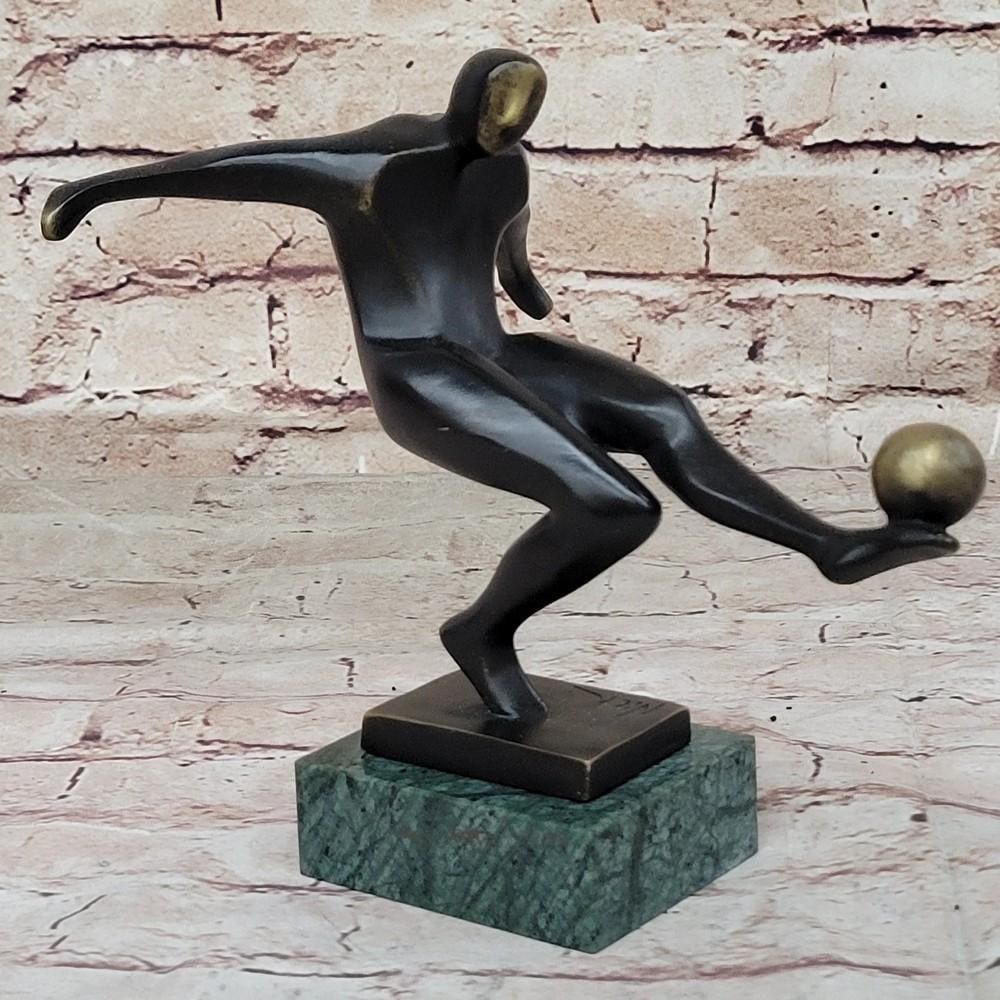 Bronze Soccer Player Sculpture by Nick - 7.5'' x 8'': Bronze Soccer Player Sculpture by Nick - 7.5" x 8" This dynamic bronze sculpture vividly captures the essence of soccer prowess as a player navigates the grassy field with agility and determinat