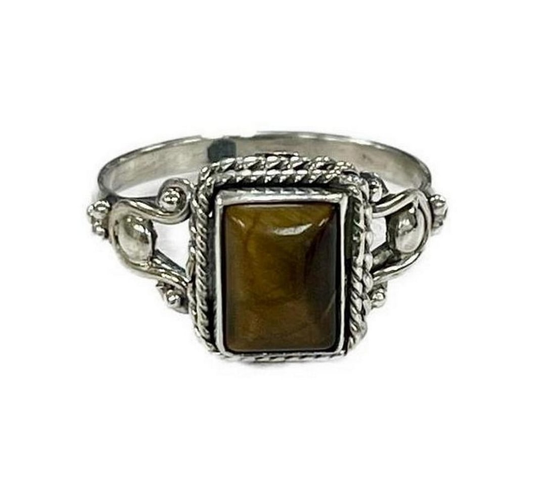 Tiger's Eye Tranquil Tides Silver Ring- 6: Tiger s Eye Tranquil Tides Silver Ring- 6 Embrace the serenity of nature with our Tiger s Eye Tranquil Tides Silver Ring. This exquisite piece of jewelry captures the essence of inner calm through its