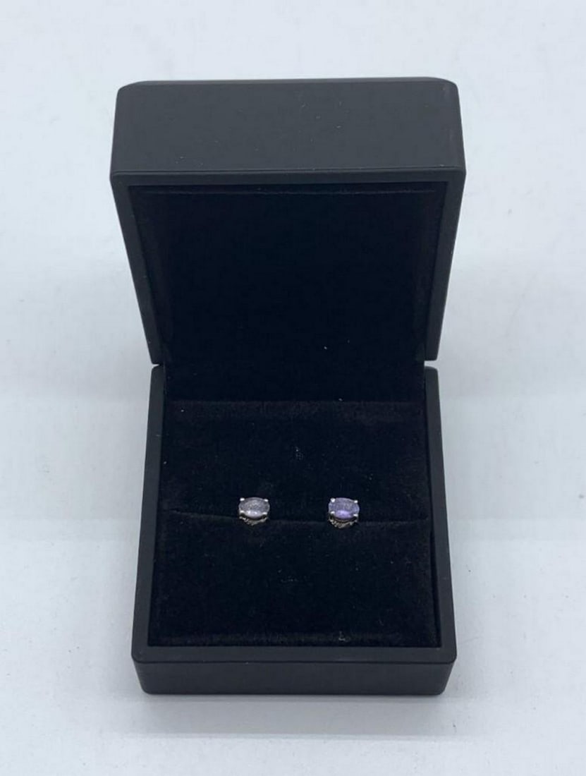 Tanzanite Stud Earrings Set in Sterling Silver: Tanzanite Stud Earrings Set in Sterling Silver This gorgeous purple gemstone is linked to various positive and mystical attributes. It is believed that tanzanite has the power to transform negative th