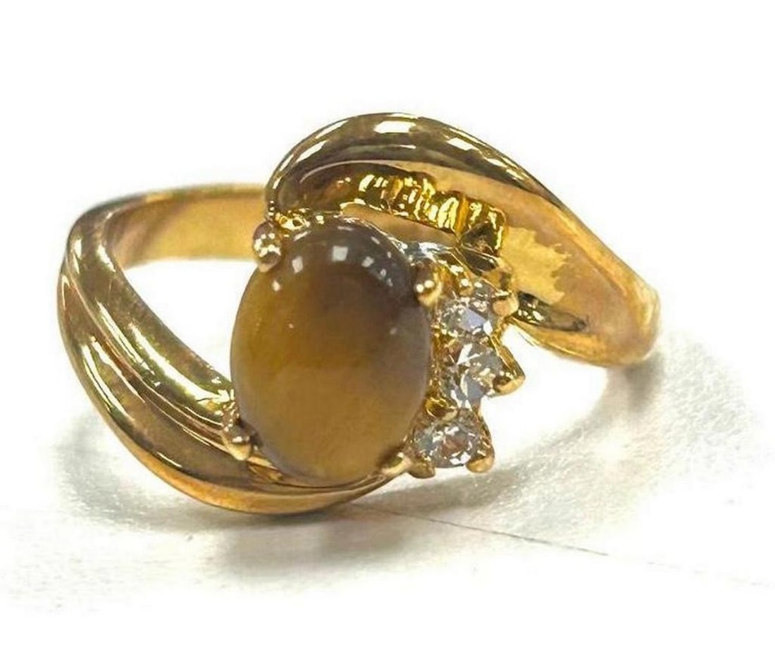 Twisted Tension Setting Tigers Eye and Austrian Crystal 18KTGP Ring Size 6: Twisted Tension Setting Tigers Eye and Austrian Crystal 18KTGP Ring Size 6 Tiger s Eye is commonly a metamorphic rock that comes in shades of reddish brown with iron stripes. The meaning of Tigers Eye