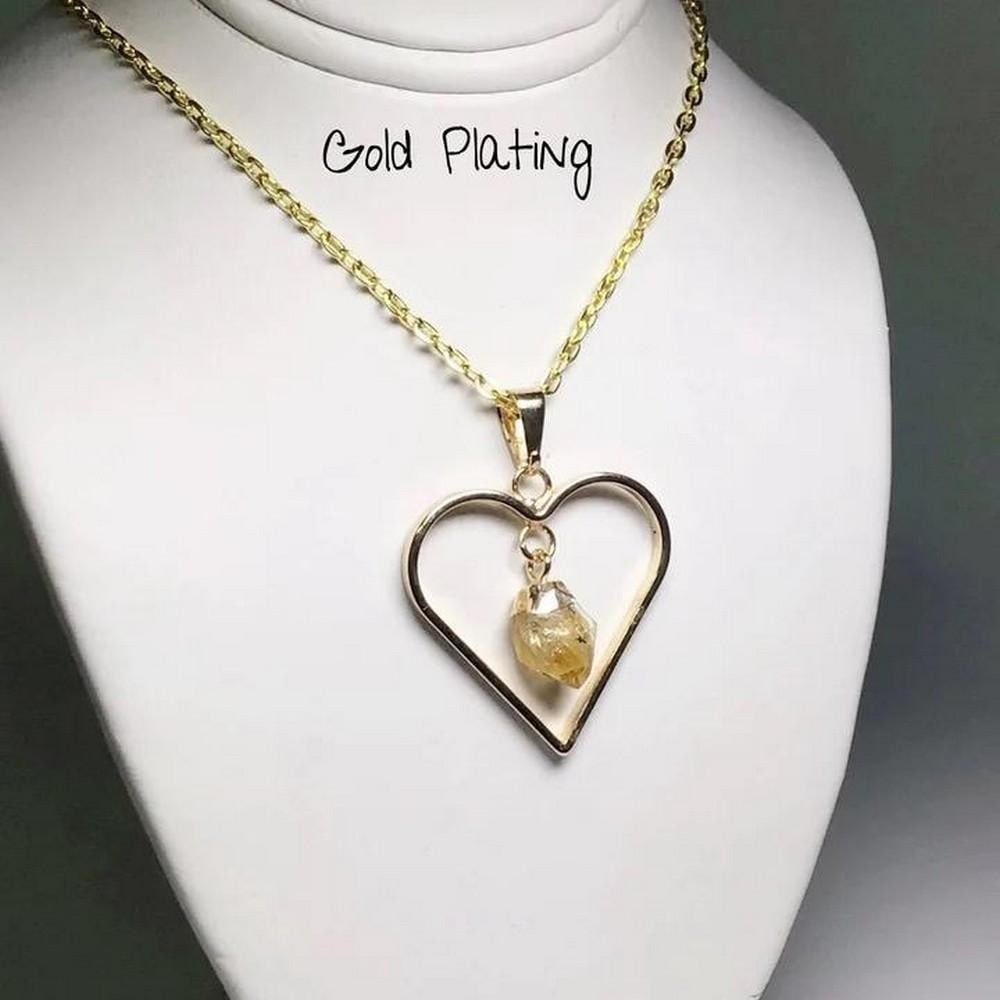 18'' Solar Embrace Citrine Heart Gold Necklace: 18" Solar Embrace Citrine Heart Gold Necklace Citrine, a radiant semi-precious gemstone, showcases its exquisite beauty through a transparent, sunshine-yellow hue that often mirrors the brilliance 