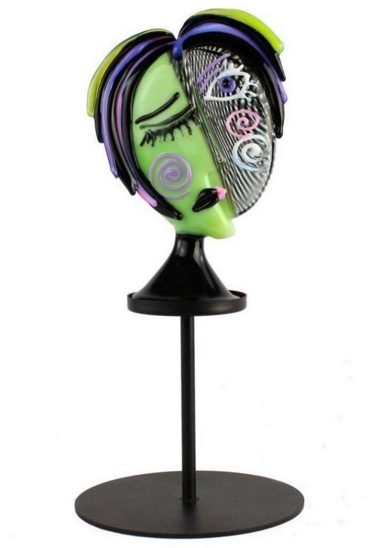 A Tribute to Picasso Green Face Figurine: A Tribute to Picasso Green Face Figurine This stunning tribute to Picasso has shades of pink and purple. It is a unique abstract piece that can really add life to any room. Dimensions: 1.2" L x