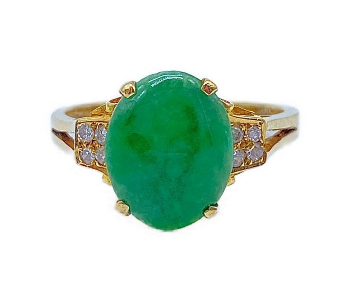 14K Gold and Natural Jade Birthstone Style Ring: 14K Gold and Natural Jade Birthstone Style Ring Set with an oval cut Jadeite Stone and 8 round cut Diamonds. Jade Total Carat Weight: 0.96ct Diamond Total Carat Weight: 0.01ct Please view photos for f