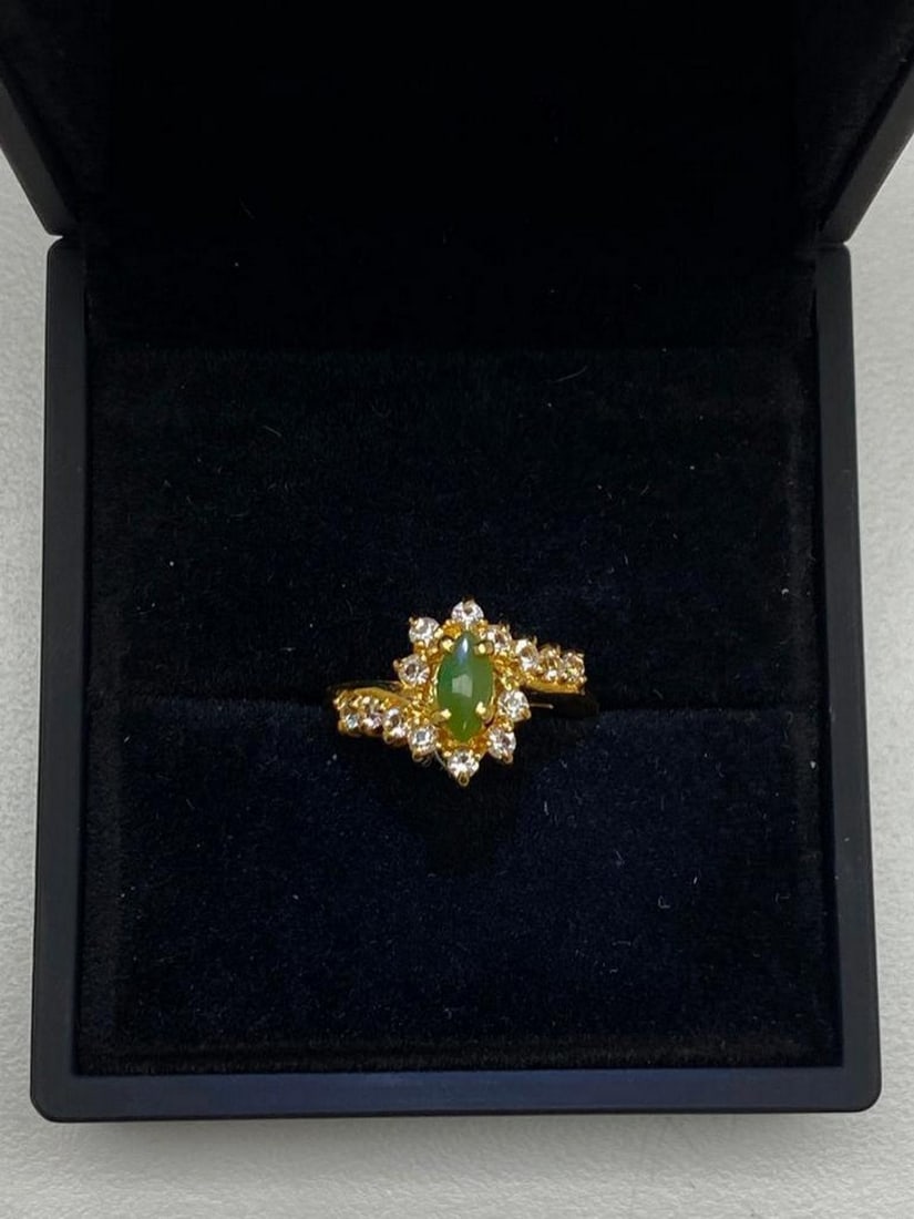 One of a Kind Jade and Austrian Crystal Gemstone Ring: One of a Kind Jade and Austrian Crystal Gemstone Ring. Distinctive and unique green Jade stone surrounded by Austrian crystals on a 18KTGP Band.Green Jade is believed to improve kidney and heart