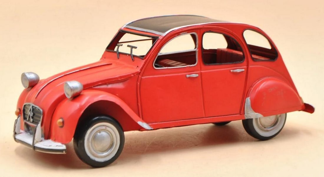 Citroen 2CV Red Die Cast Model Car: Citroen 2CV Red Die Cast Model Car Add sporty style to any space with our 1950 Citroen 2CV model. Featuring a rustic iron frame and detailed red-trimmed metal exterior, it's a charming vintage accent 