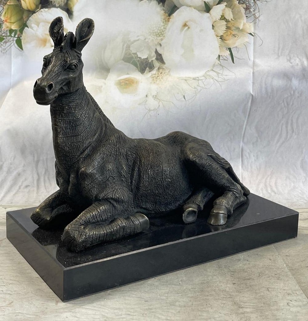 African Zebra Bronze Sculpture: African Zebra Bronze Sculpture This stunning Bronze Zebra Sculpture by artist Milo," showcases the unique nature-inspired style and singular expression of its creator with its breathtaking and grav