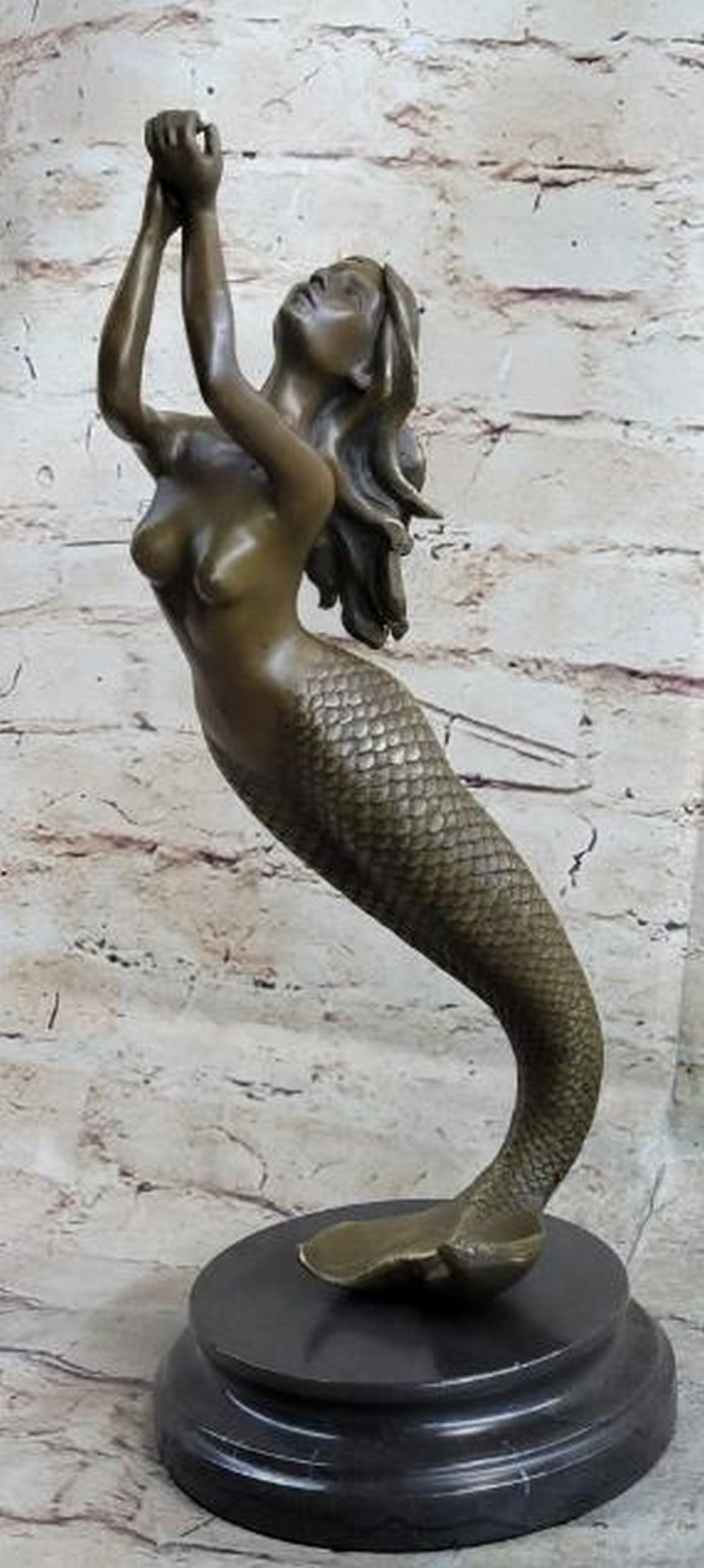 Beautiful Nude Mermaid Bronze Statue: Beautiful Nude Mermaid Bronze Statue. The beautiful mermaid can be imagined, holding herself up with her fishtail, among the ocean` s body of her water kingdom. Her arms are raised and cupped as he