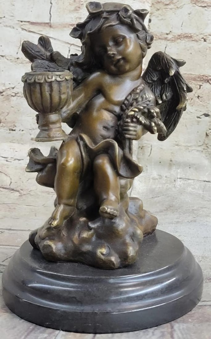 8.5'' Tall Cherub Holding Celebration Cup Bronze Figure On Marble Base - 8lbs: 8.5 Tall Cherub Holding Celebration Cup Bronze Figure On Marble Base - 8lbs This adorable candle holder is of a young Cherub holding a spiraling plant. He rests on the edge of a rock and cradles the