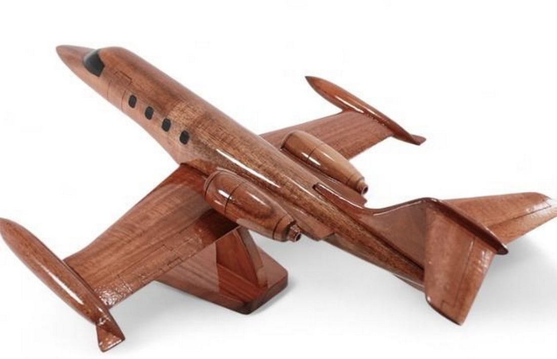 Mahogany Lear Jet 35 Scale Model: Mahogany Lear Jet 35 Scale Model This detailed Lear Jet 35 scale model is handcrafted from solid mahogany with a high-gloss finish. Featuring finely carved details and natural wood grain, it makes a
