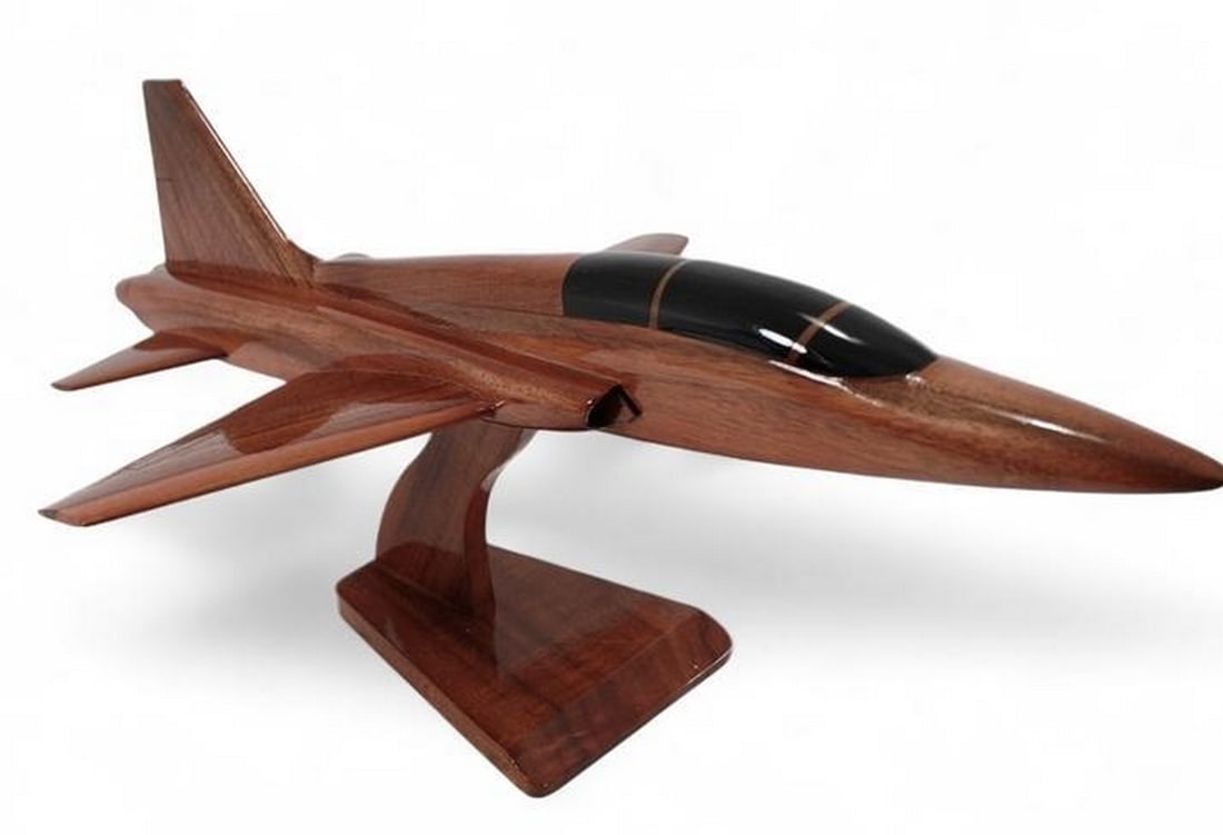 T-38 Talon: T-38 Talon This handcrafted model of the T-38 Talon is a remarkable scale replica in solid mahogany. Movable props, hand carved details, and three coats of polyurethane finish add up to an