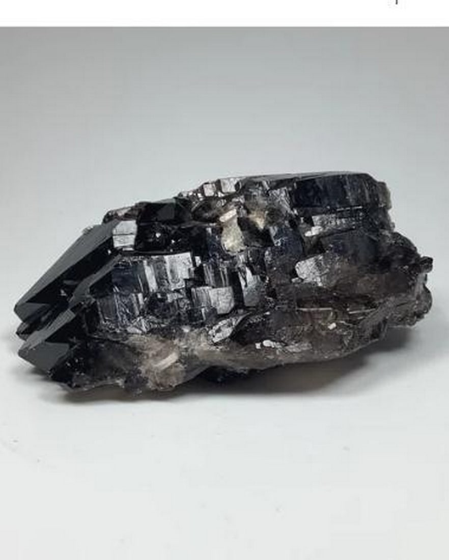 Smoky Quartz Enchantment: Twilight Cluster: Smoky Quartz Enchantment: Twilight Cluster. A captivating display of nature s artistry that embodies the mysterious allure of twilight. This stunning cluster features rich, translucent smoky quartz