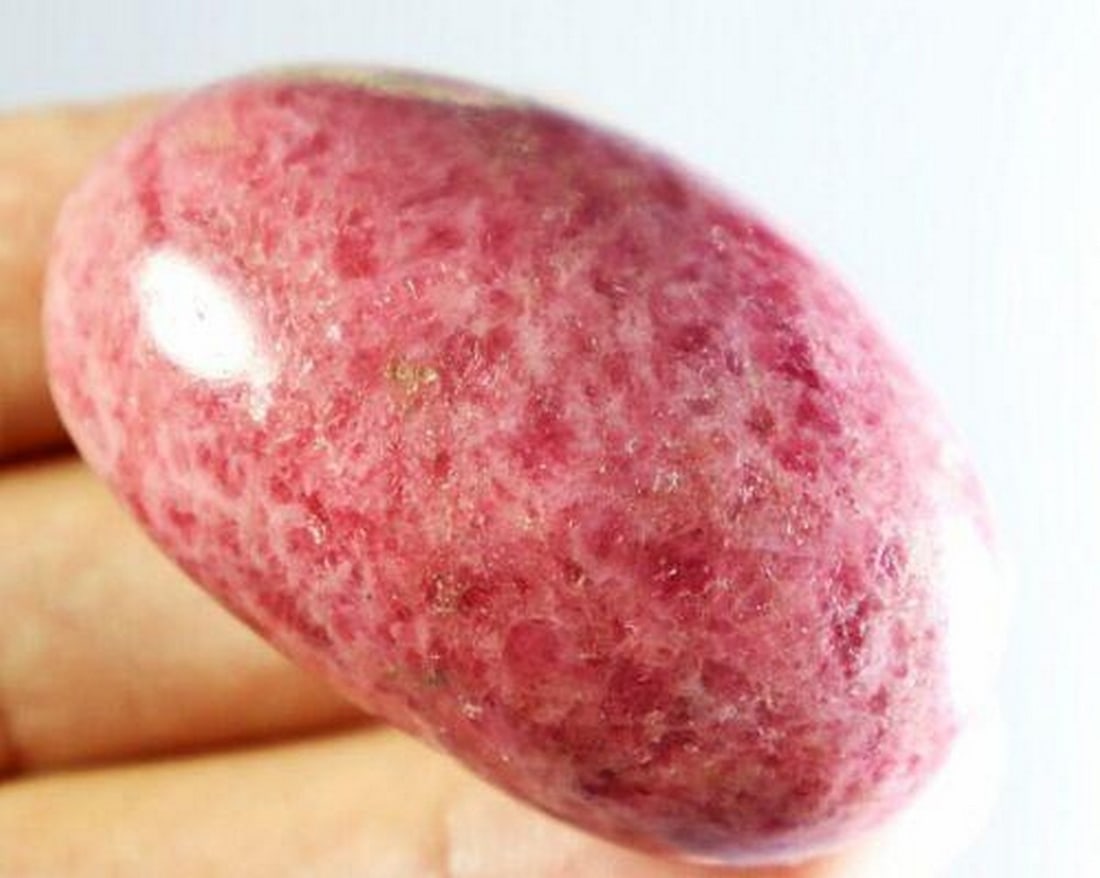 Polished Red Rhodonite Quartz Crystal with Tourmaline Cab Palm Stone: Polished Red Rhodonite Quartz Crystal with Tourmaline Cab Palm Stone A beautifully polished red rhodonite quartz crystal palm stone, featuring natural tourmaline cabochon inclusions. Perfect for energ