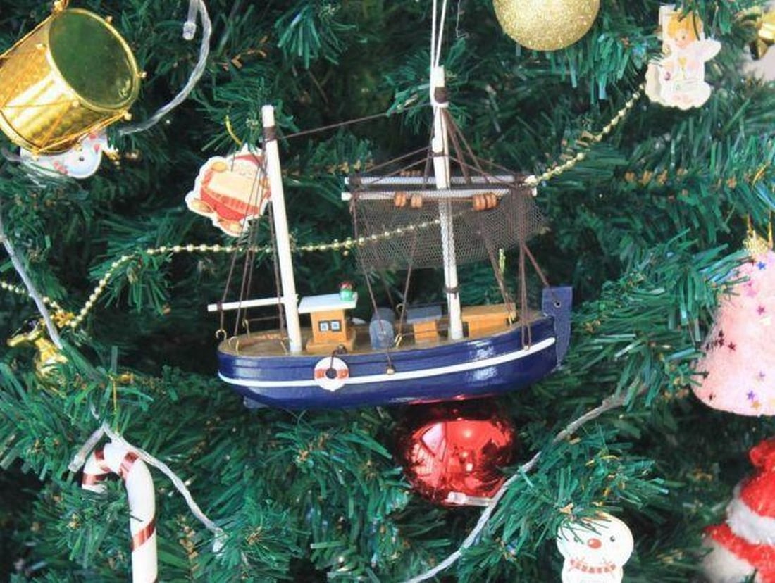 Fisher King's Delight: Wooden Boat Ornament: Fisher King's Delight: Wooden Boat Ornament. A charming and intricately crafted addition to your holiday decor. This delightful ornament captures the spirit of fishing adventures with its beautifully 