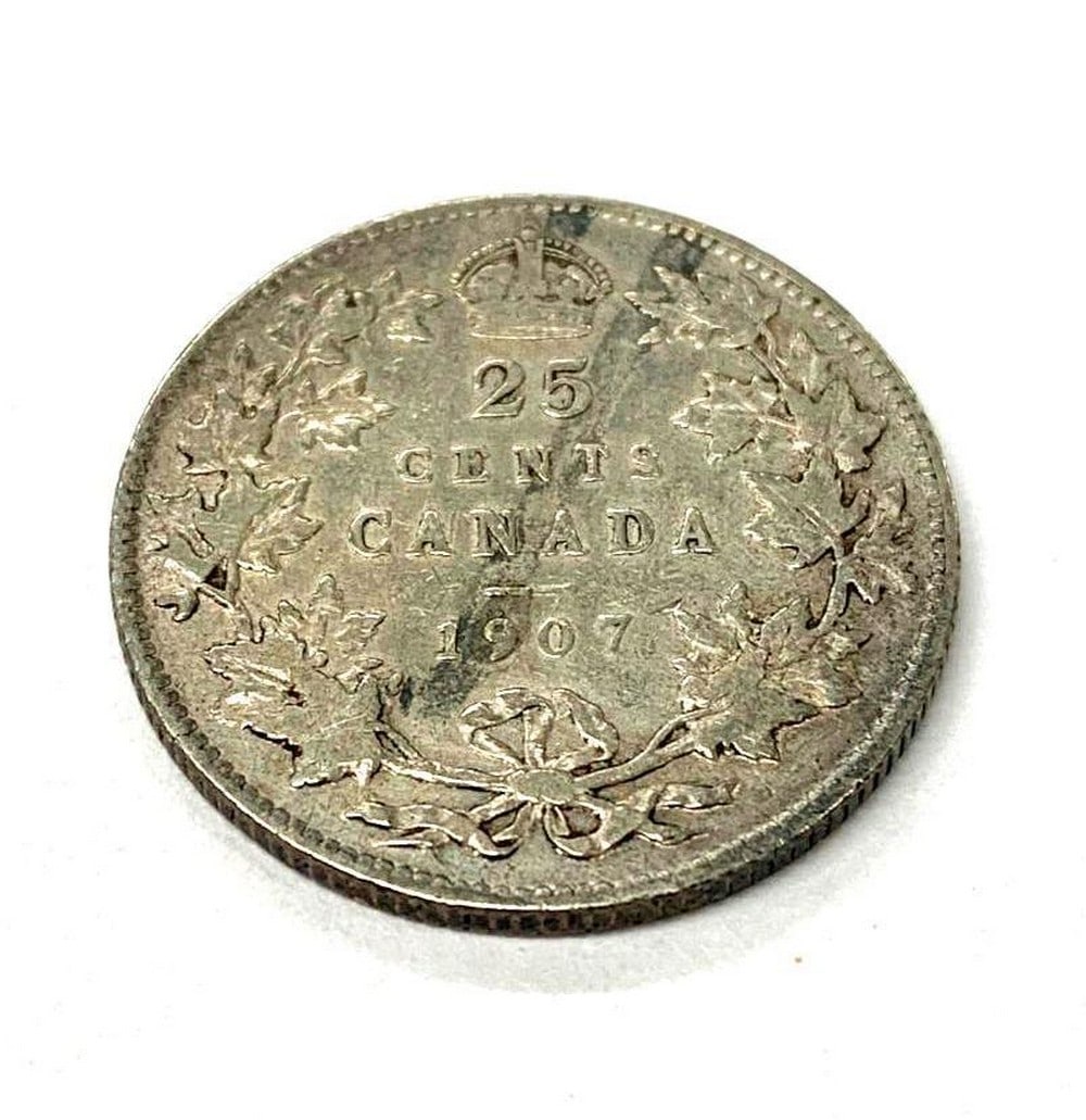 1907 Canadian 25 Cent Coin: The obverse of the coin shows Edward VII facing towards the right, while the reverse side denominates a date within a wreath with a crown above it. Alloy: 92.5% silver, 7.5% copper