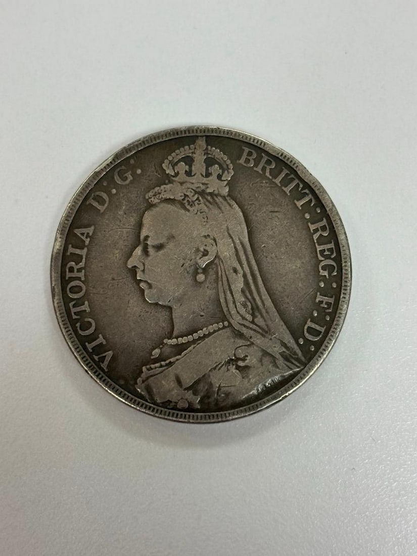 1889 British Crown: Obverse Crowned and veiled bust ( Jubilee Head ) of Queen Victoria left, legend around. Lettering: VICTORIA D: G: BRITT: REG: F: D: Translation: Victoria by the Grace of God Queen of the Britains Defe