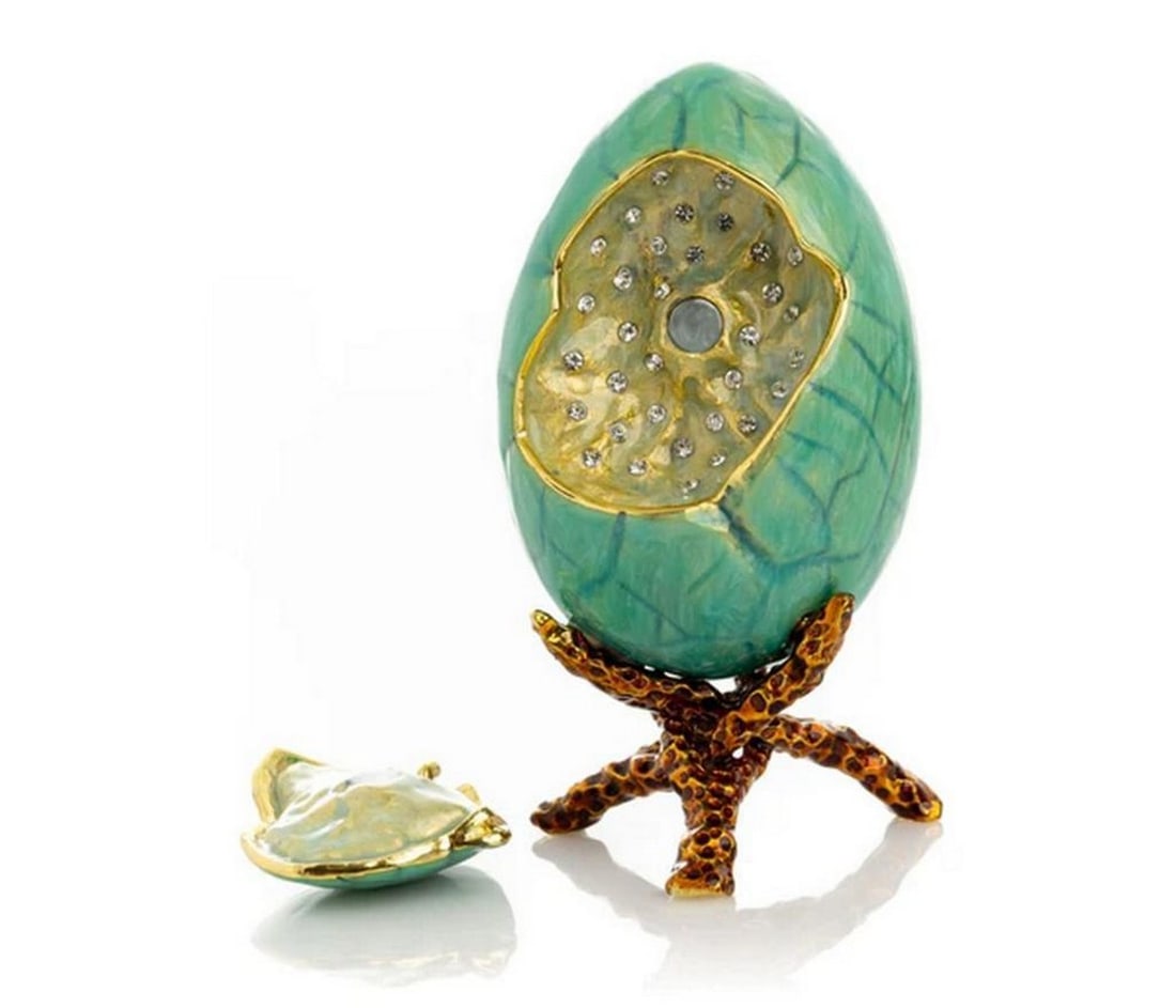Lush Turquoise Faberge Egg: Lush Turquoise Faberge Egg Indulge in luxury with our Lush Turquoise Faberge Egg, plated with 24K gold for an exquisite touch of opulence. Each crystal is handpicked and artistically placed on the pie