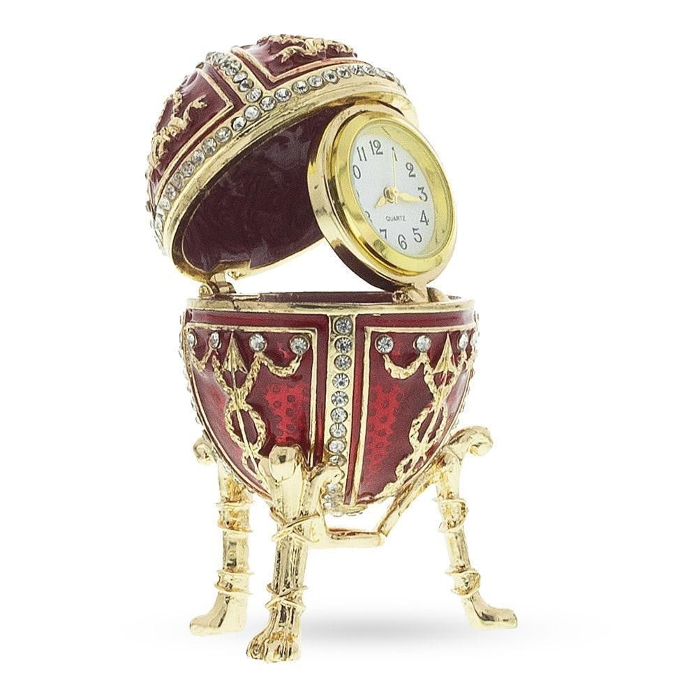 1895 Rosebud Royal Russian Inspired Egg with Clock: 1895 Rosebud Royal Russian Inspired Egg with Clock Surprise 2.9 Inches Tall x 1.7 Inches Wide 7.366 cm Tall x 4.318 cm Wide Enameled Gold Plated Pewter Battery Operated Clock This hand-painted