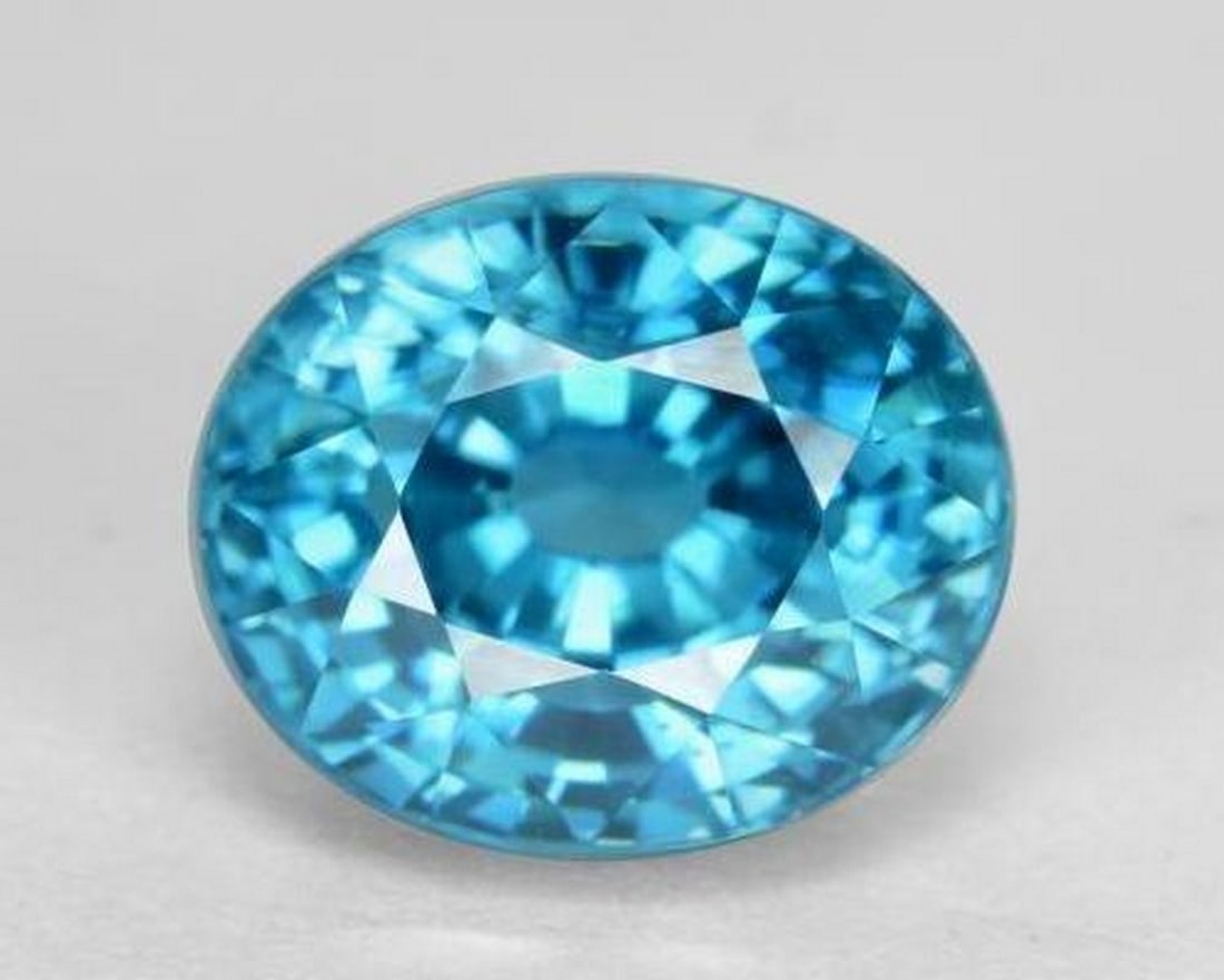 5.74 ct Electric Blue Zircon, Oval Cut, VVS, Cambodia: 5.74 ct Electric Blue Zircon, Oval Cut, VVS, Cambodia Natural zircon gemstone weighing 5.74 ct, cut in a brilliant oval facet shape with an intense electric blue color. The gem measures 9.20 x 7.66 x 
