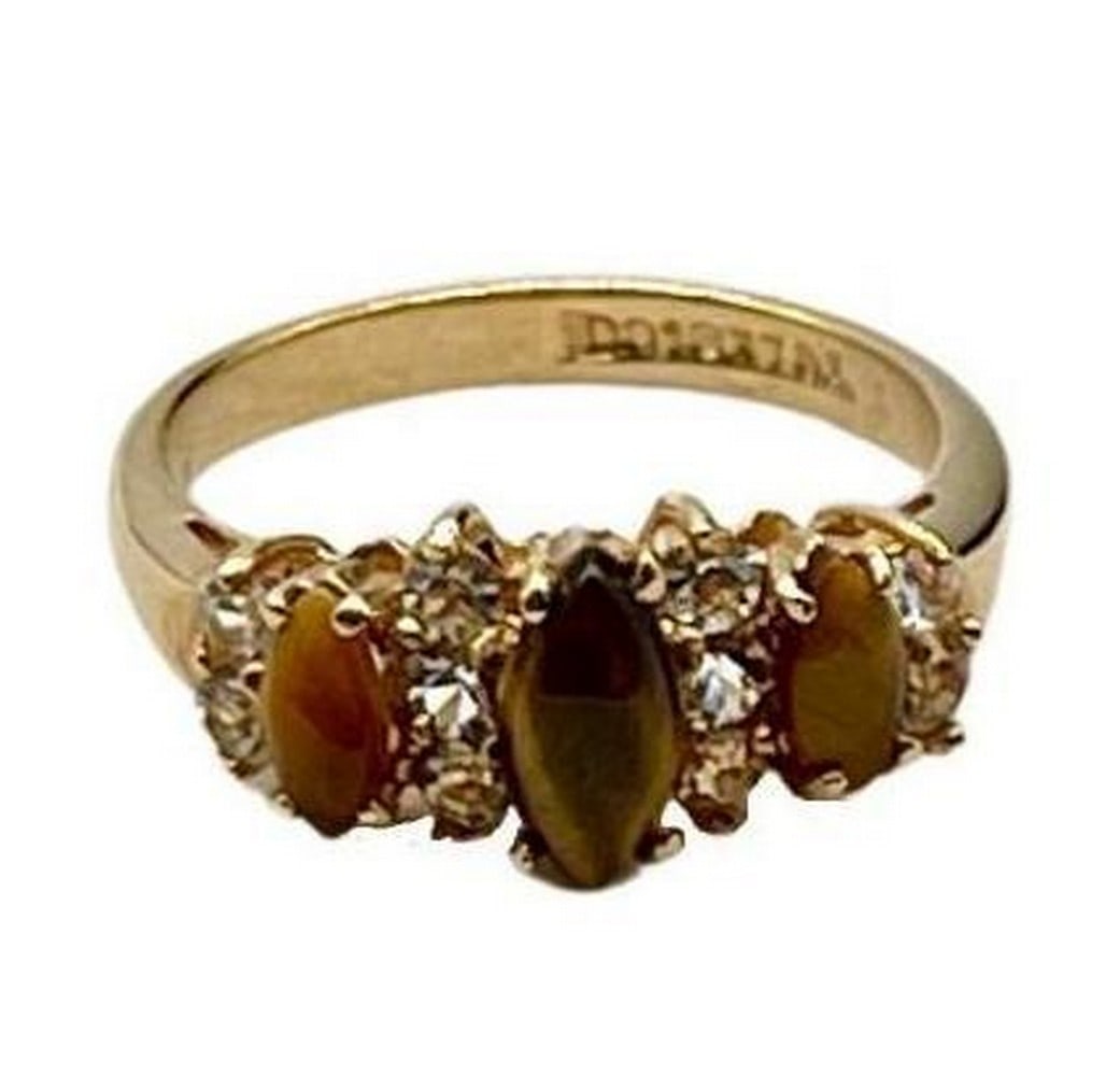 Tiger's Gleam Ring: Tiger s Gleam Ring This striking gold electroplated ring features three polished tiger's eye stones, each accented by sparkling white crystals for added brilliance. The warm tones of the tiger's eye