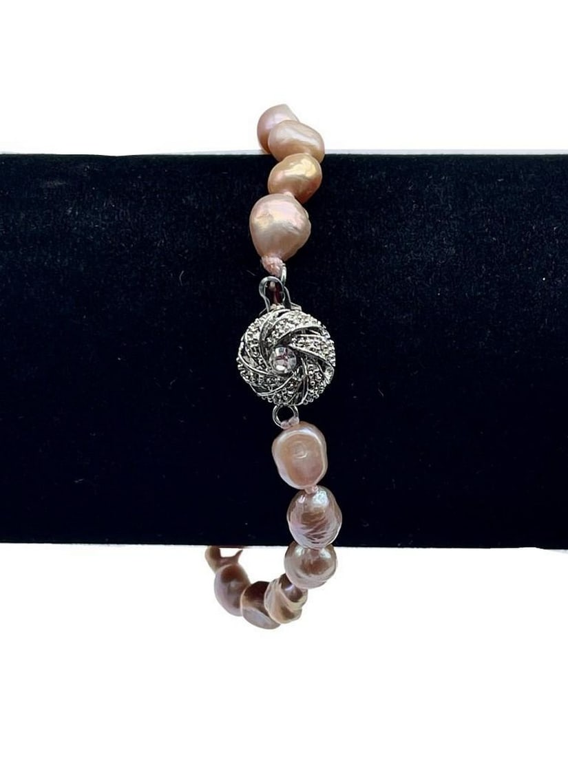 Coral Blush Pearl Bracelet: Coral Blush Pearl Bracelet This elegant 8-inch bracelet features lustrous coral blush pearls strung together for a timeless and feminine look. Its soft, warm hues make it a versatile accessory that
