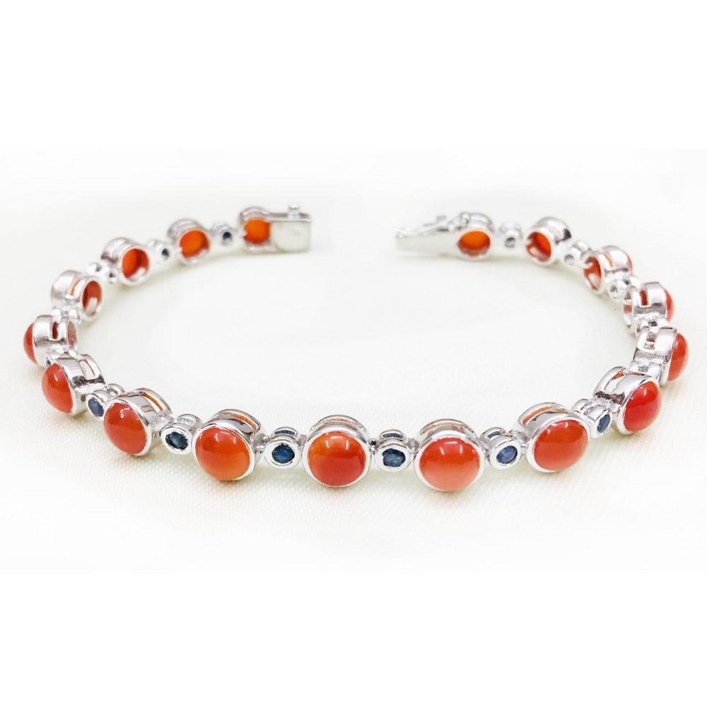 Carnelian and Sapphire Studded Bracelet: Carnelian and Sapphire Studded Bracelet Carnelian is a semi-precious gemstone known as a stabilizing stone, it is said to restore vitality and motivation, and stimulate creativity. View Photos For