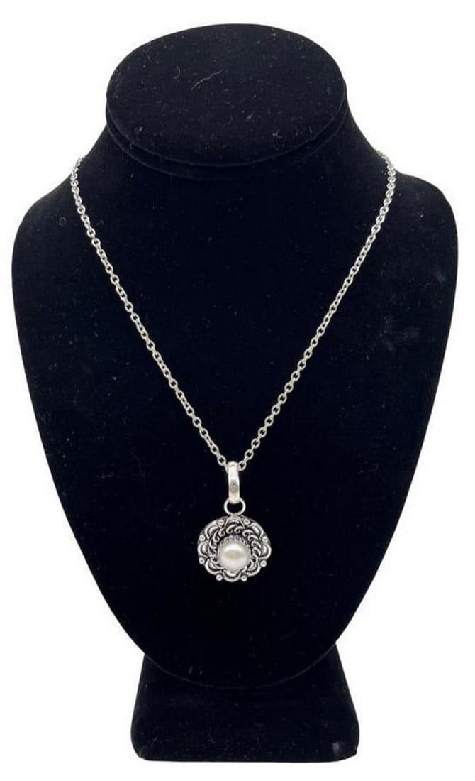 925 Sterling Silver River Pearl Necklace: 925 Sterling Silver River Pearl Necklace This 925 sterling silver necklace have a silver designed pendant with a river pearl in the center. Necklace Length: 27" View photos for further details.
