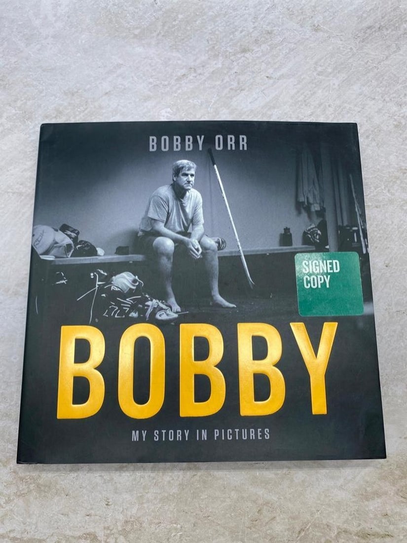 HOF Legend Bobby Orr ''My Story In Pictures'' Signed Copy With COA: HOF Legend bobby Orr ''My Story In Pictures'' Signed Copy With COA. This book is in amazing condition, There's Very little ware on the corner and edges. Comes With Stadium Heroes COA. View