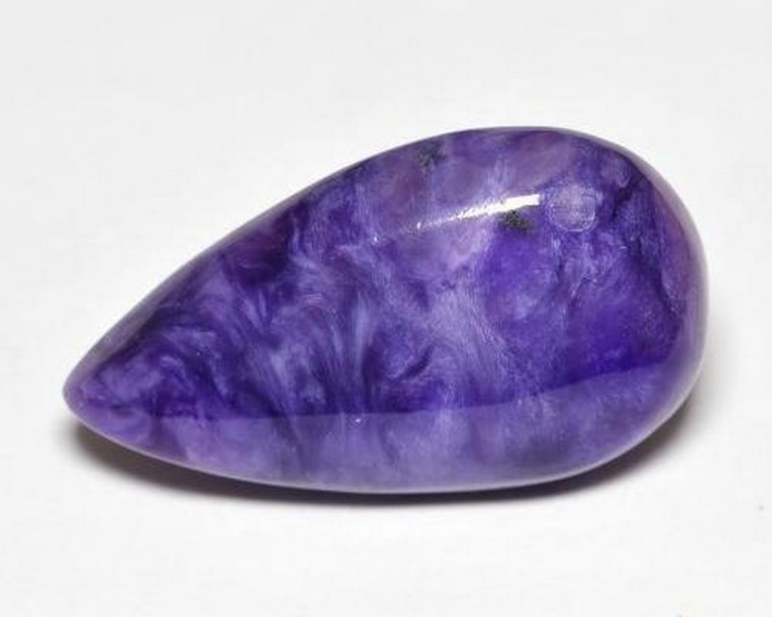 10.22 ct Natural Medium Dark-Violet Charoite, Pear Cabochon, Opaque, Russia: 10.22 ct Natural Medium Dark-Violet Charoite, Pear Cabochon, Opaque, Russia Natural charoite gemstone weighing 10.22 ct, cut in a pear cabochon shape with a medium dark-violet color. The gem measures 