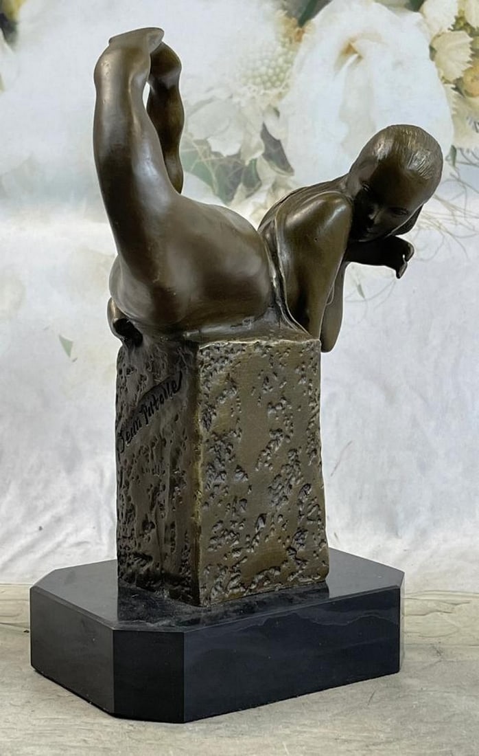 Bronze Mermaid Figure Sculpture - 9" x 7": Bronze Mermaid Figure Sculpture - 9" x 7" This bronze sculpture depicts a mermaid resting on a rocky perch with finely detailed scales, flowing hair, and surrounding seashells. A crown of flow